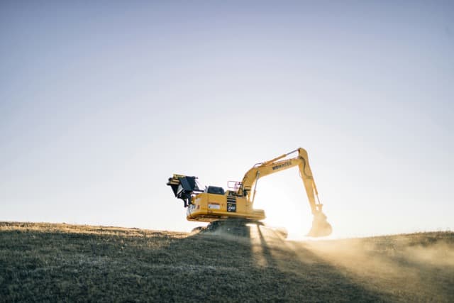 Excavator on site at 20675 Eastleigh Crescent, groundbreaking underway